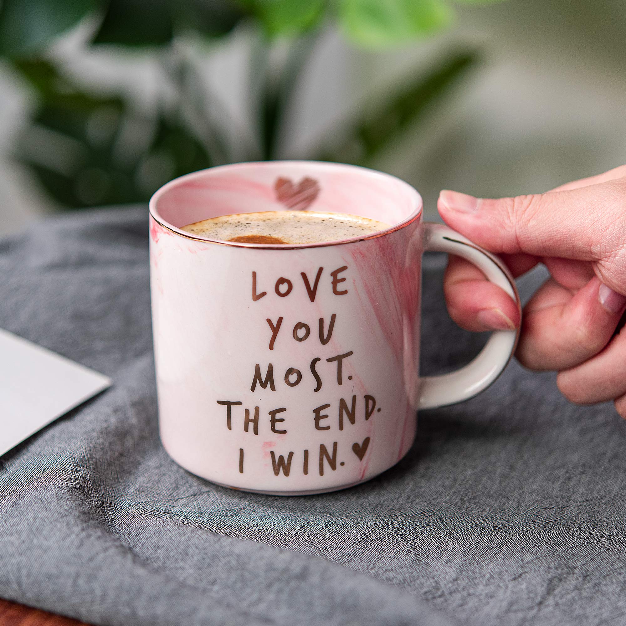 Golden accents on pink marble mug close up