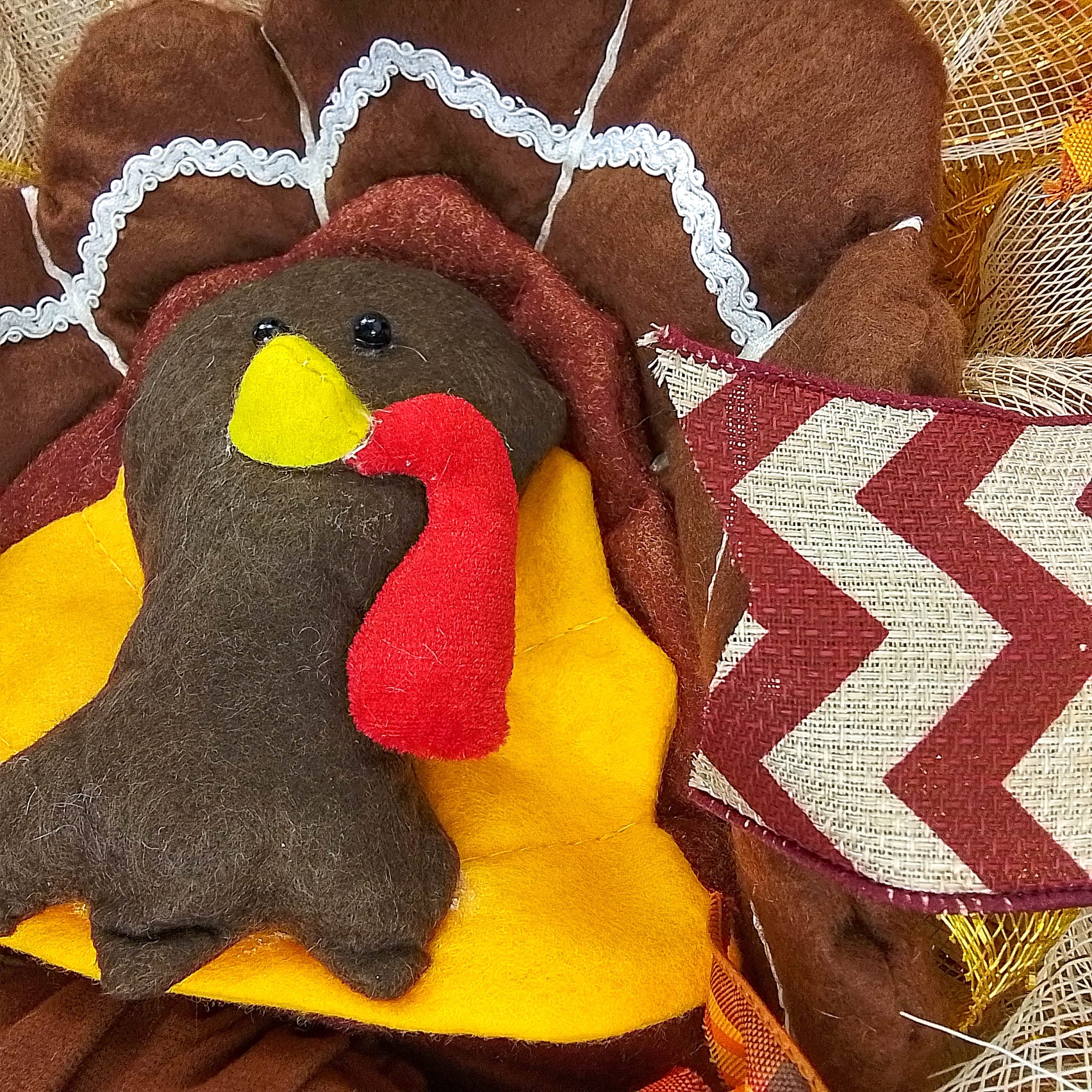 Indoor outdoor wreath with turkey centerpiece and decorative tail mesh