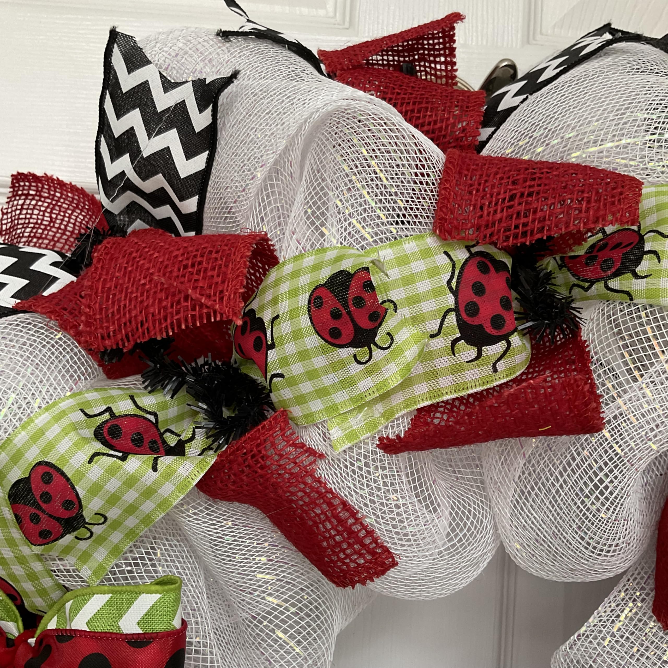 Wreath featuring black and white chevron ribbons and bow