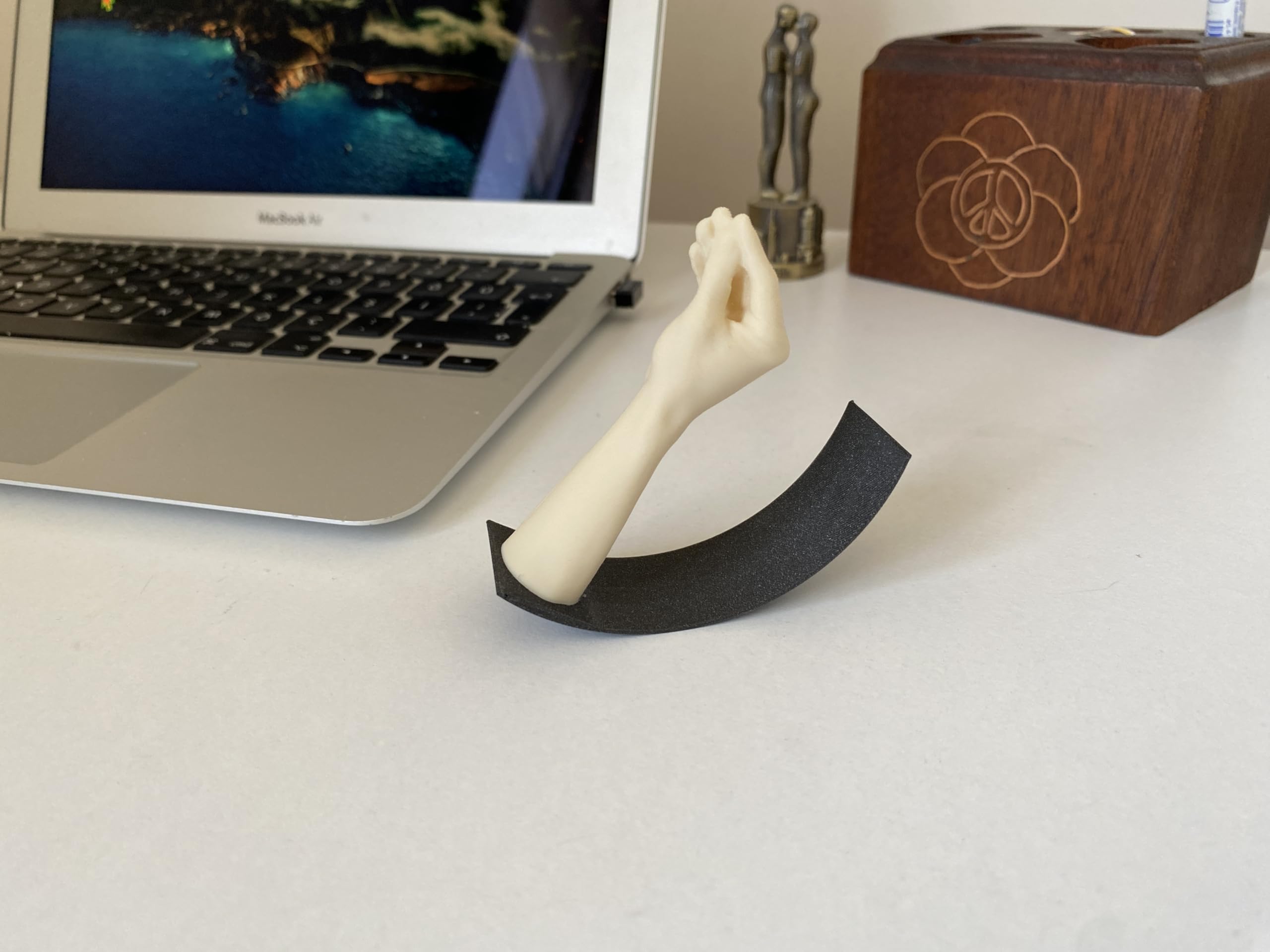 Italian Hand Gesture Desk Toy displayed on a shelf