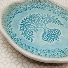 Close up of handmade marks on turquoise glaze tray