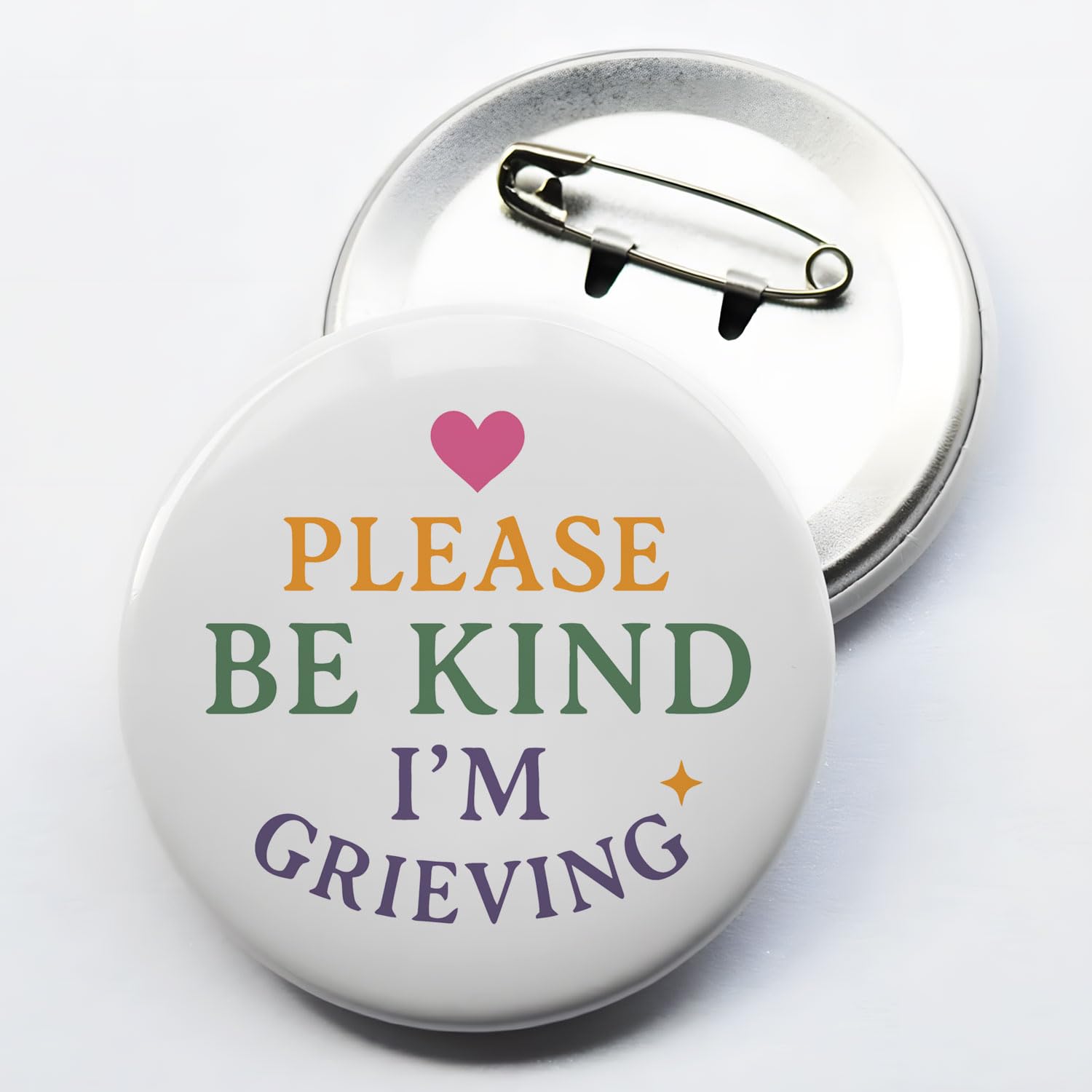 Close-up of 2.3 inch diameter grief pin text PLEASE BE KIND I'M GRIEVING