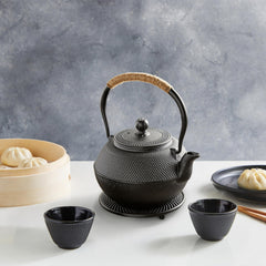 Juvale black cast iron teapot on stovetop