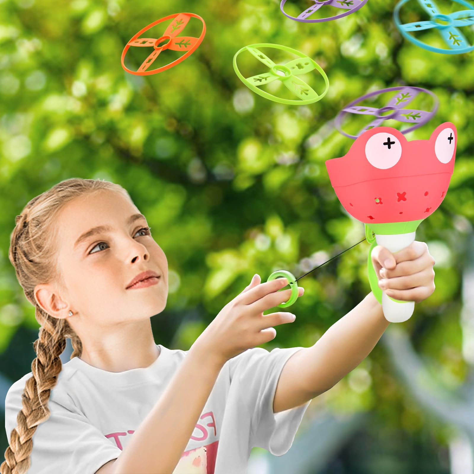 children ages 4-8 playing with flying discs outdoors
