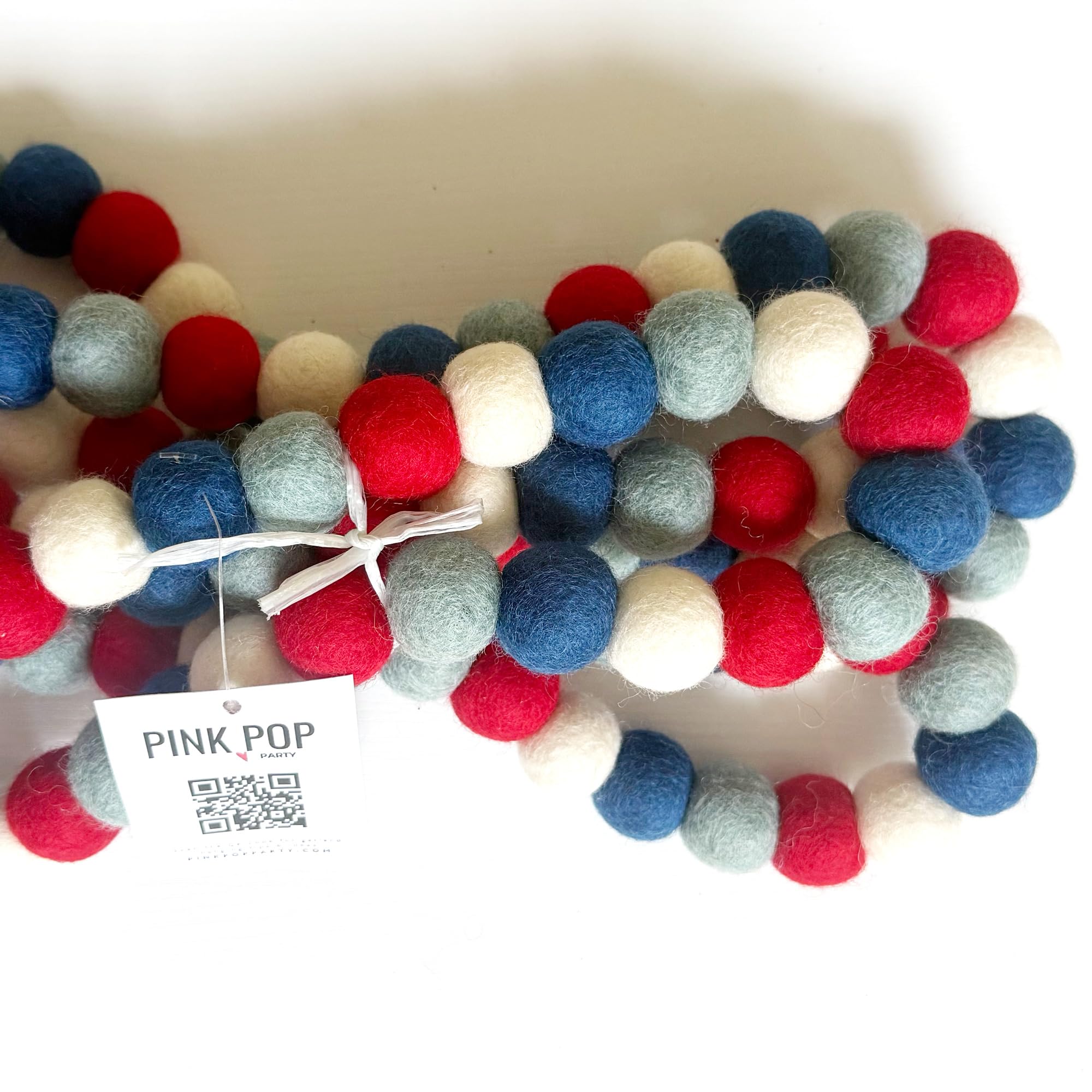 Large 9-foot garland with 3-inch red white and blue pom poms