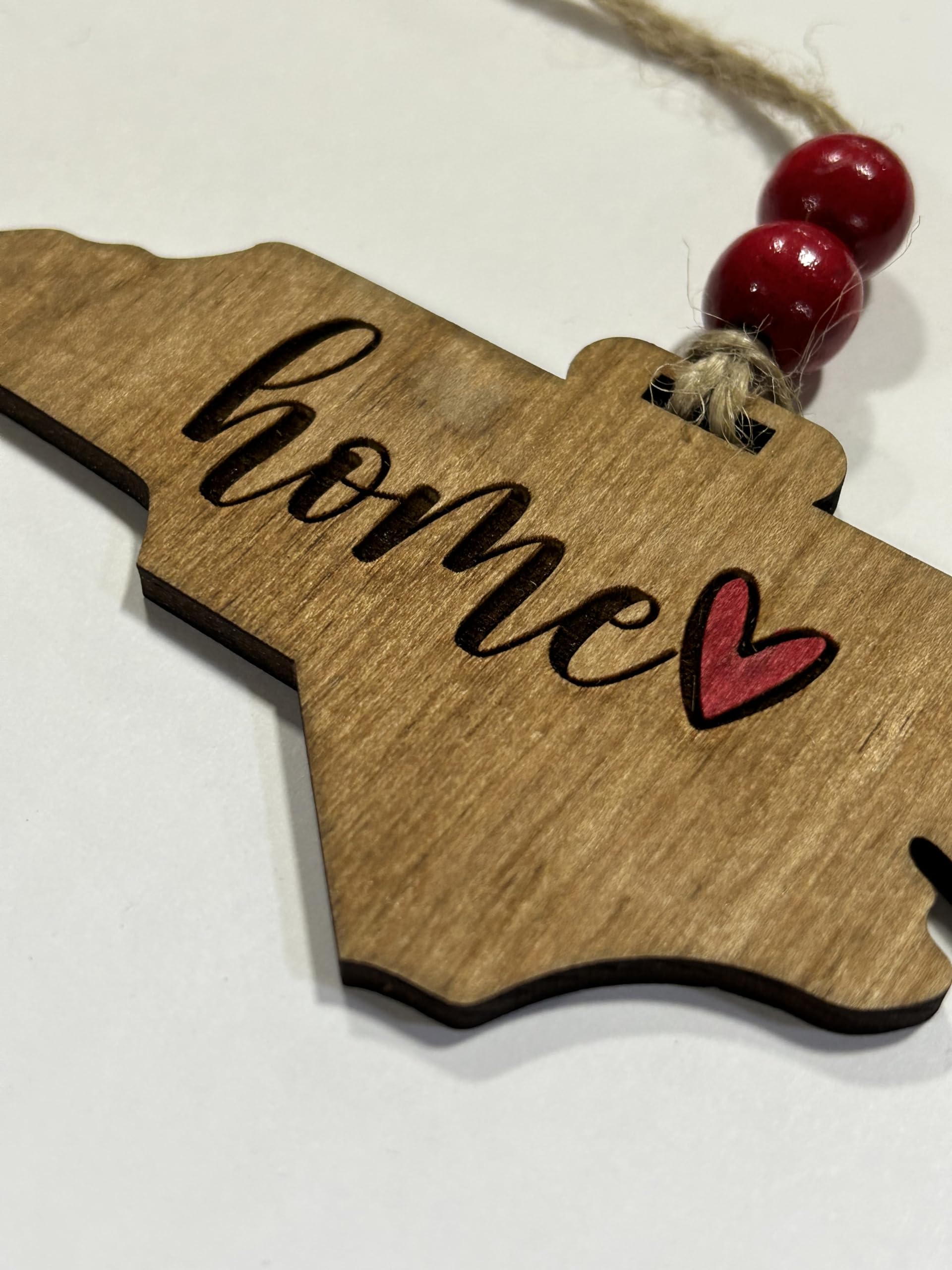 Laser cut wooden ornament celebrating North Carolina