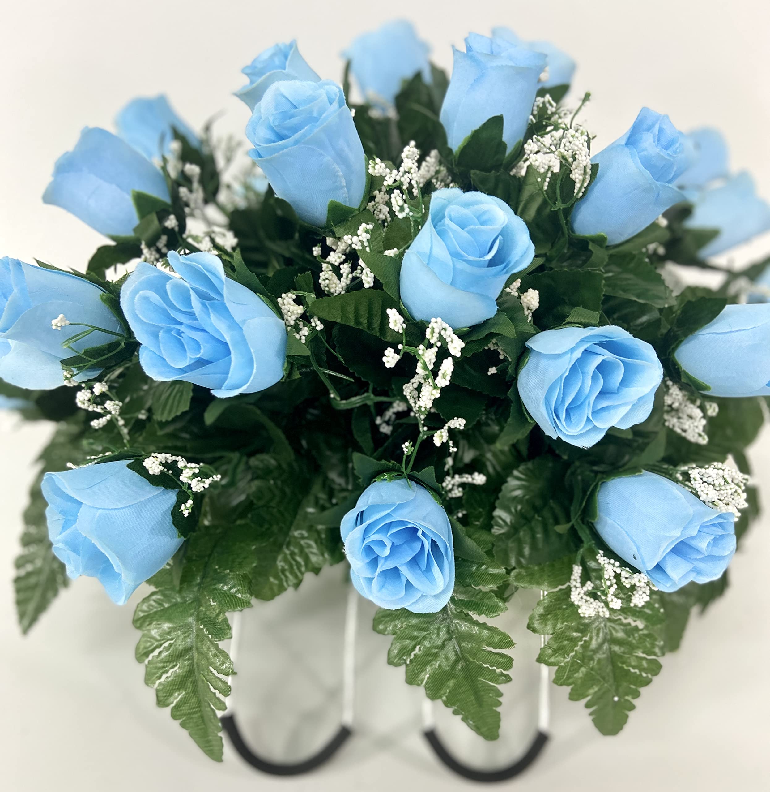 Silk flowers and greenery in cemetery arrangement for grave marker