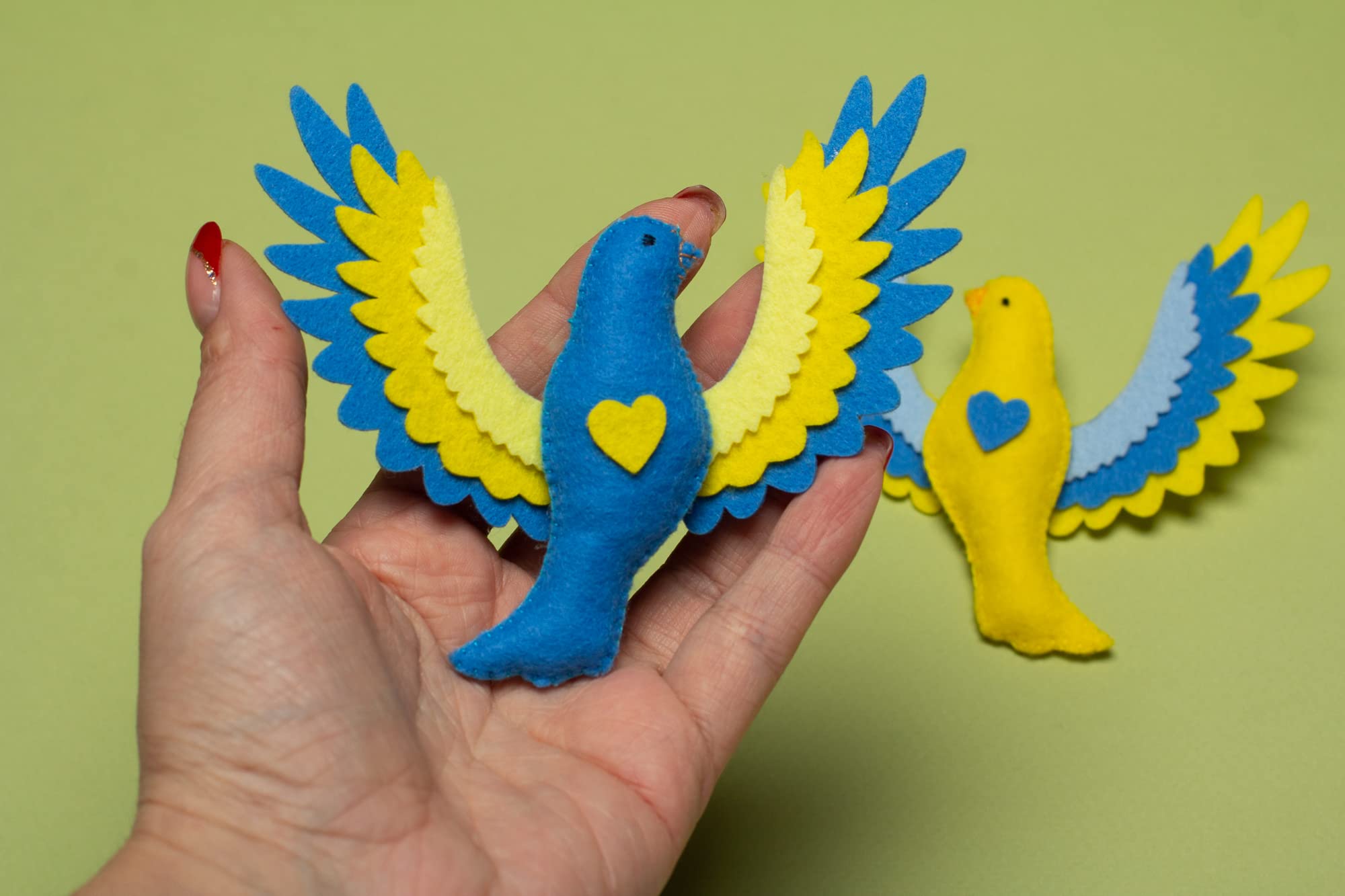 Two felt doves for holiday décor in Ukraine colors