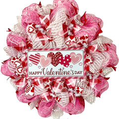 aluminum sign with lots of hearts on front door wreath