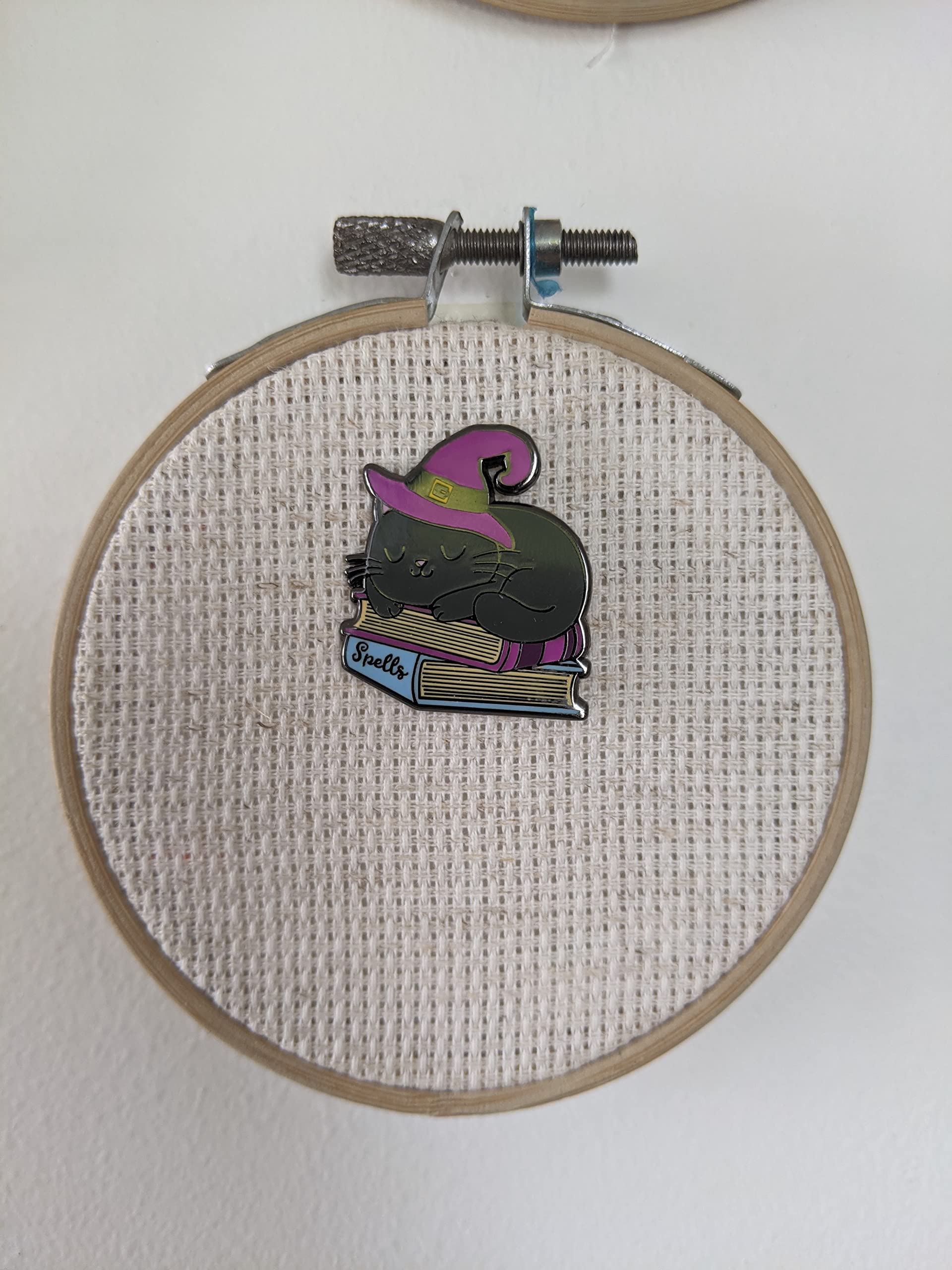 Back magnet secures needle minder to fabric