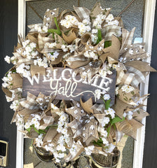 Close up view of magnolia and cotton ribbons on wreath