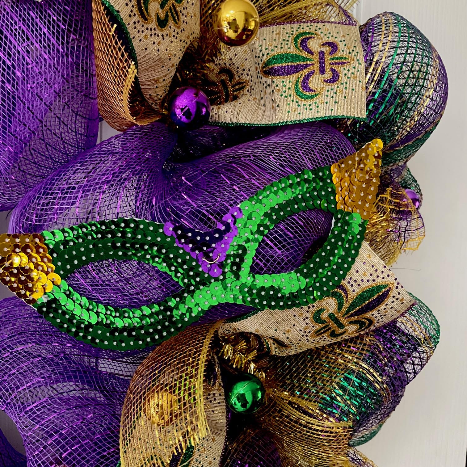 Mardi Gras front door wreath displayed on entryway