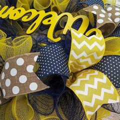Yellow welcome sign detail on wreath