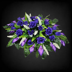 Purple roses and calla lilies silk arrangement on cemetery saddle
