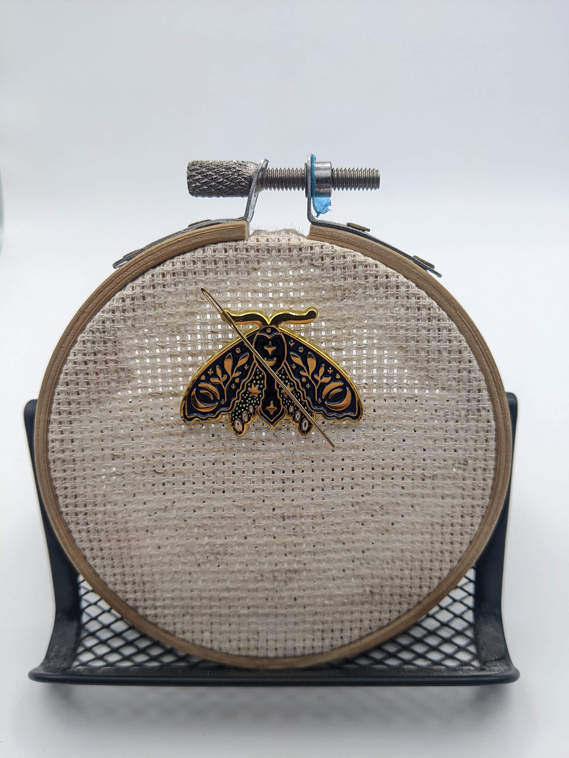 Magnetic Needle Minder showing back magnet securing needle on fabric