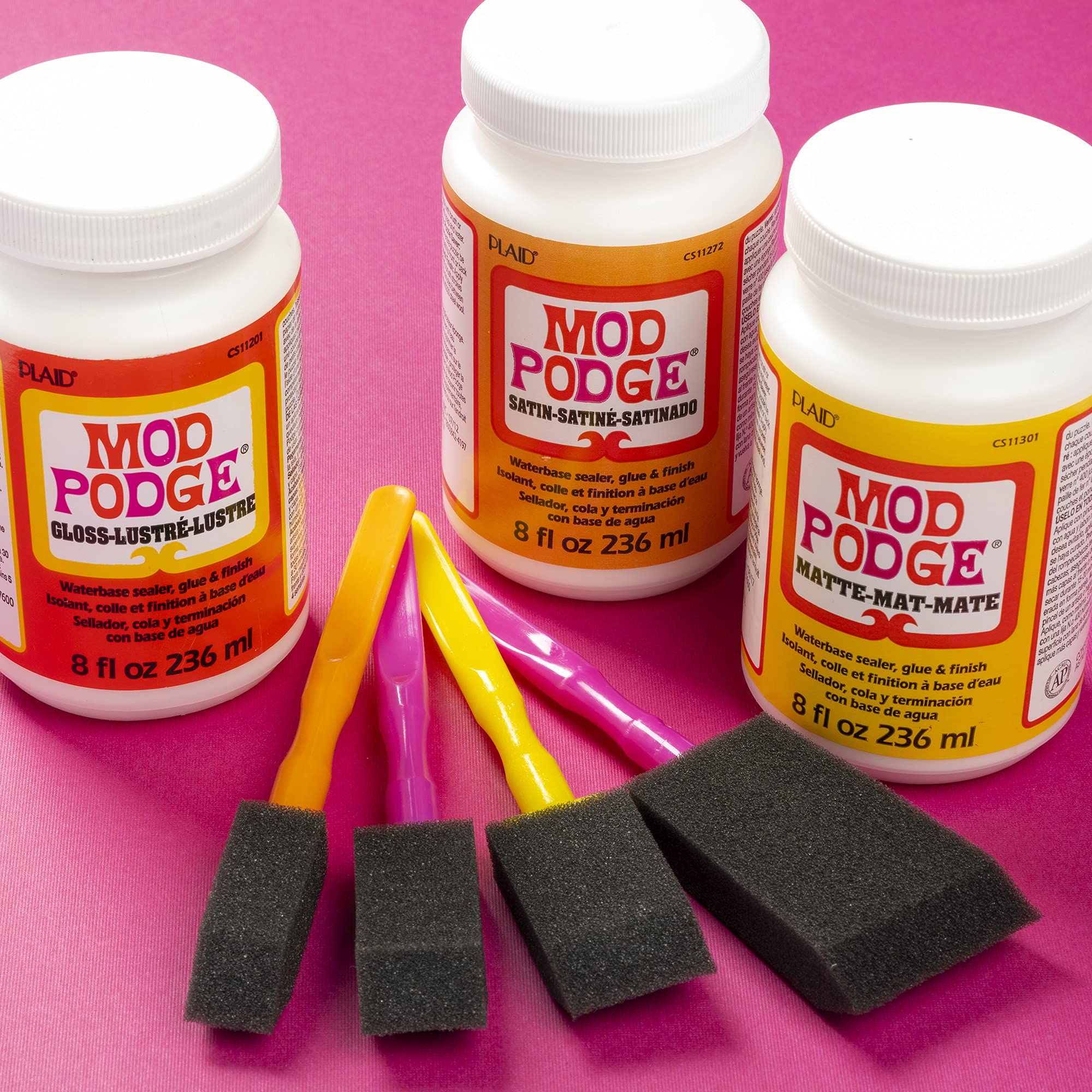 16 oz Mod Podge Gloss Sealer Glue & Finish bottle on craft table