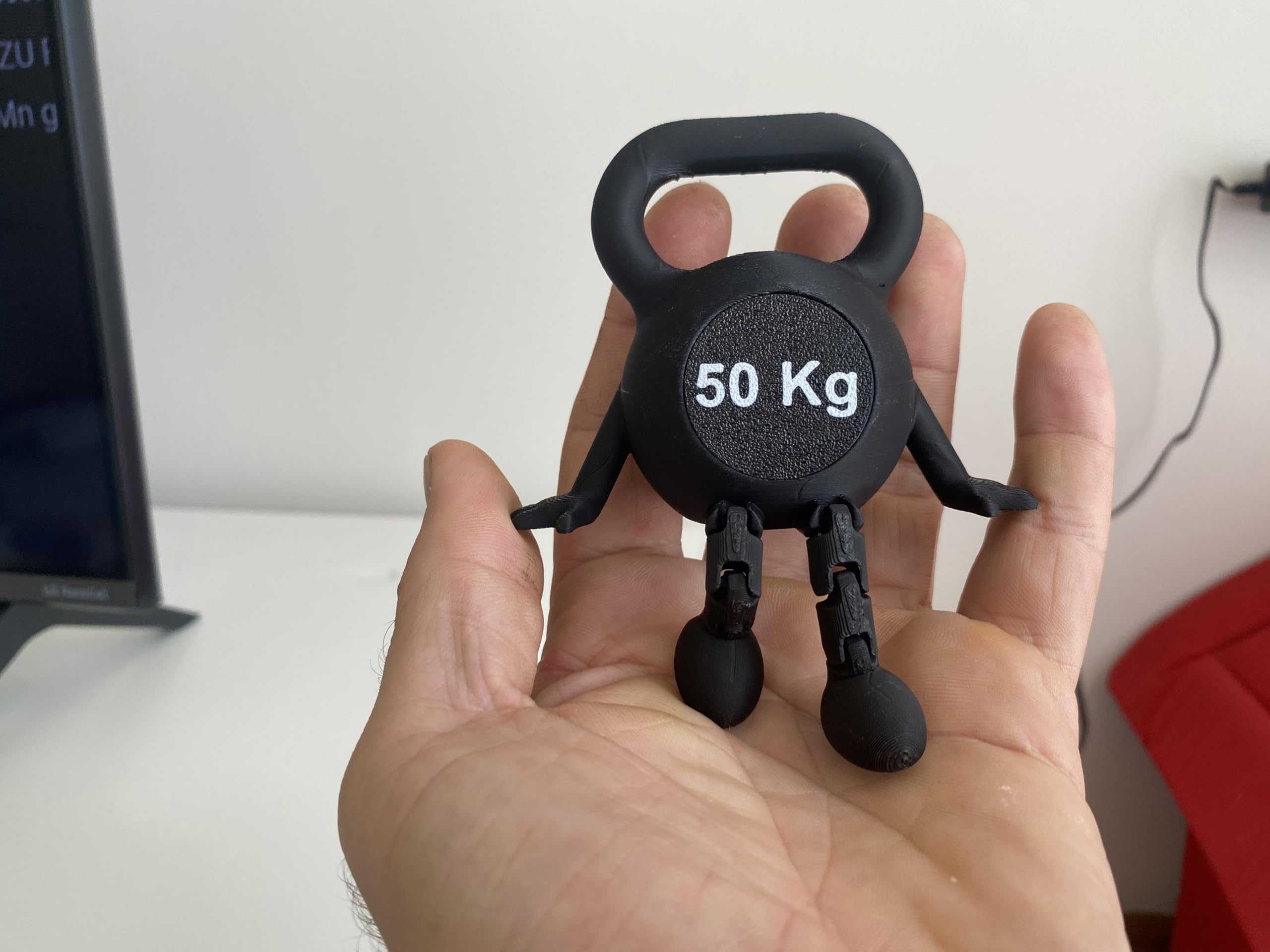 Movable legs feature on kettlebell desk sculpture