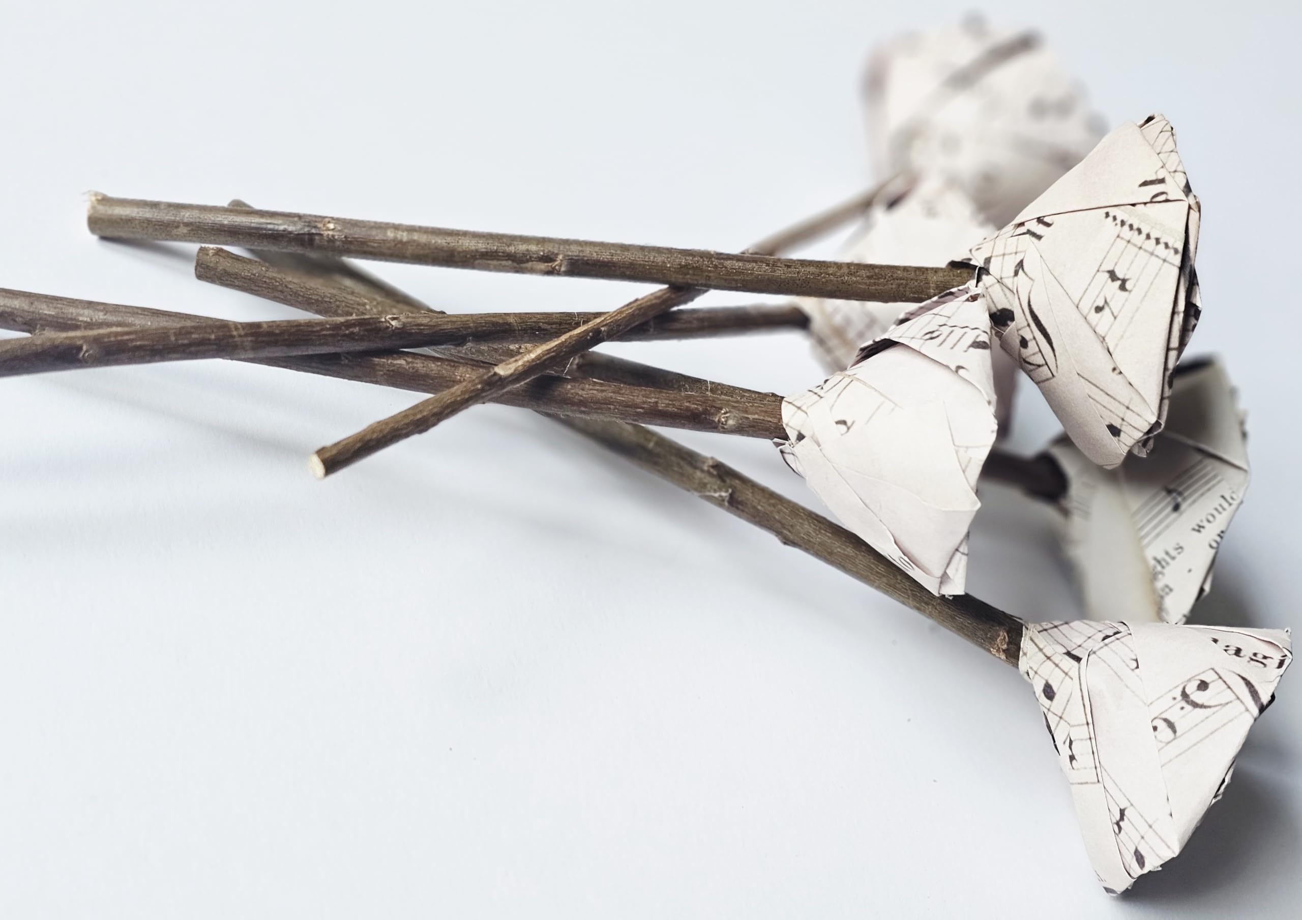 Music notes paper rose on rustic wooden stick