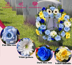 Yellow and white silk flowers on cemetery wreath