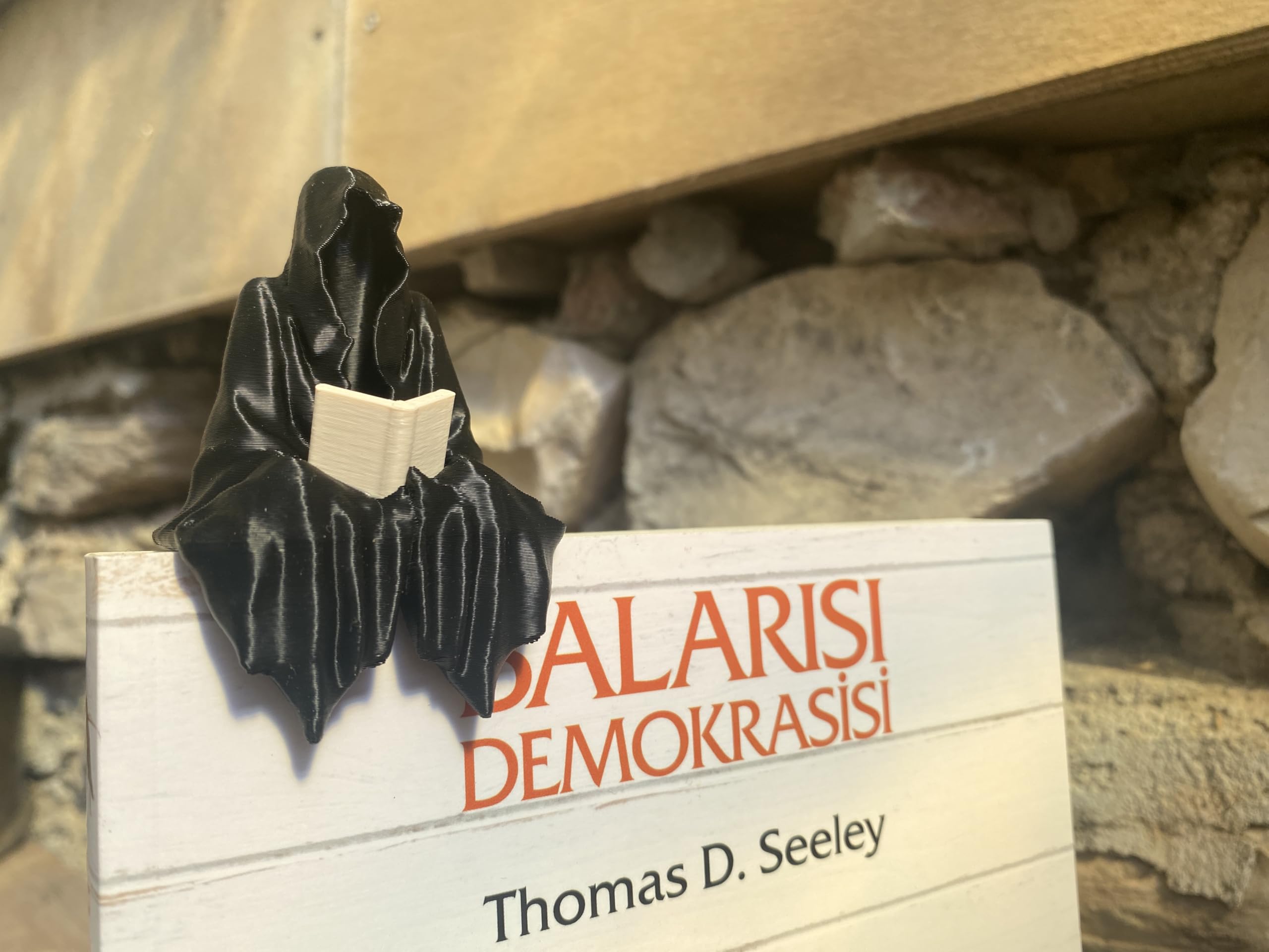 3D printed ghost figurine reading a book