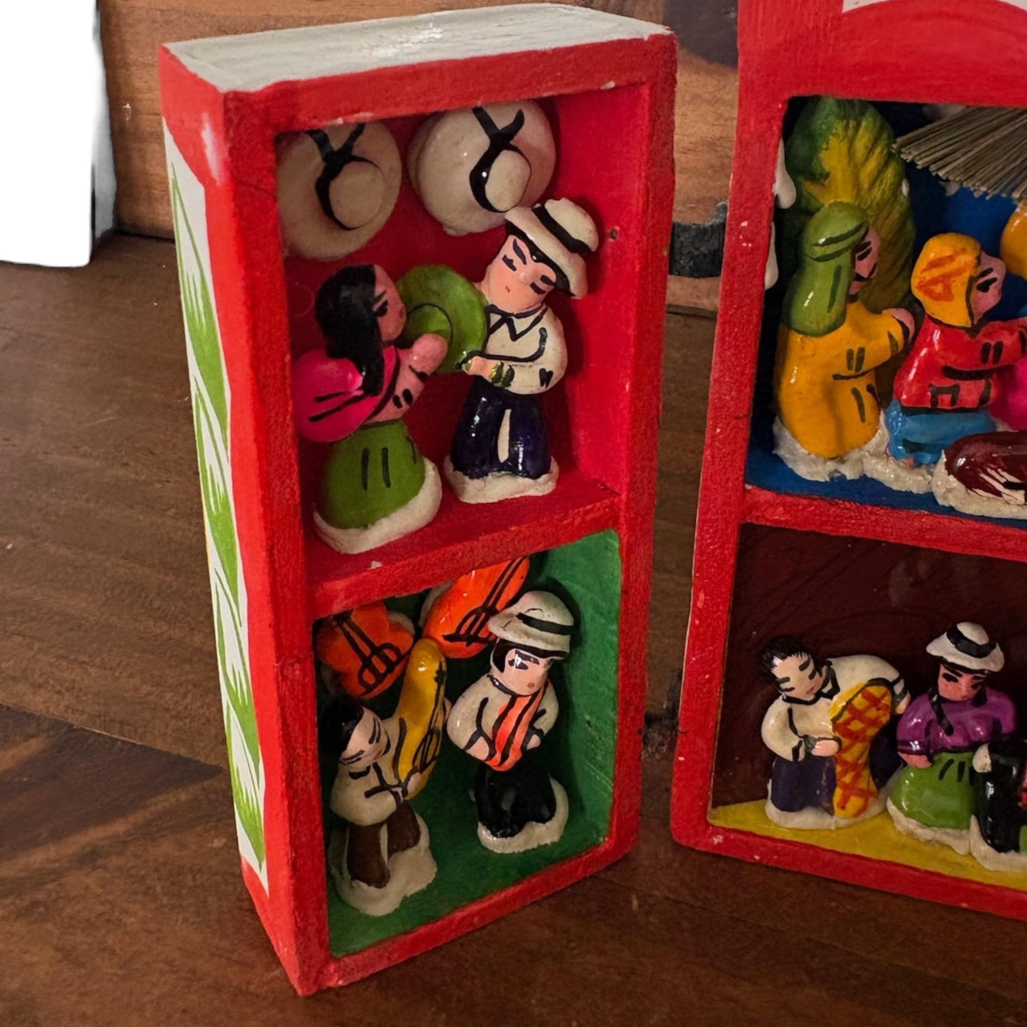 nativity scene housed behind wooden retablo door