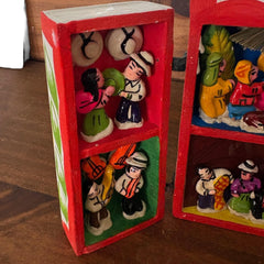 nativity scene housed behind wooden retablo door