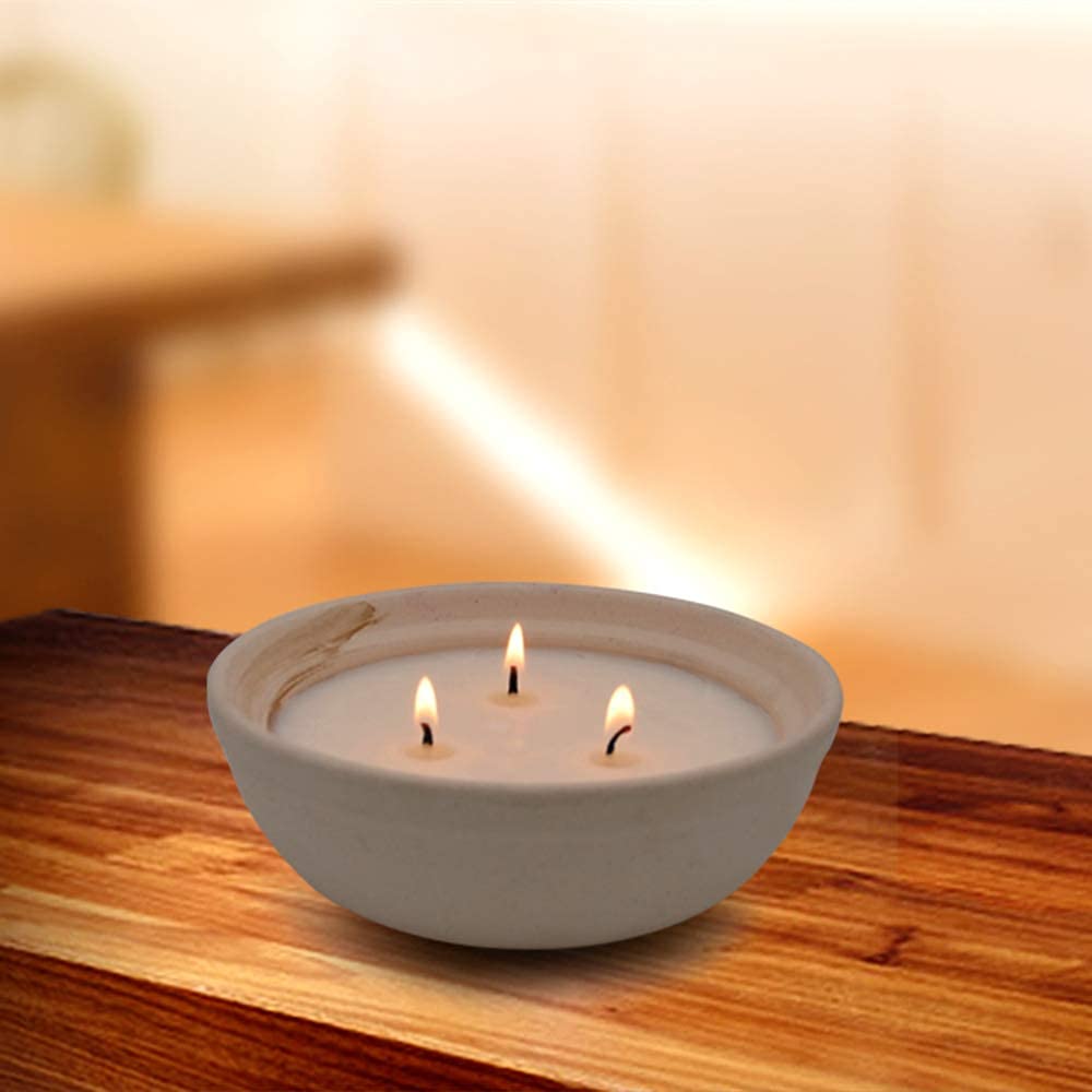 Close up of handmade pottery jar housing citronella candle