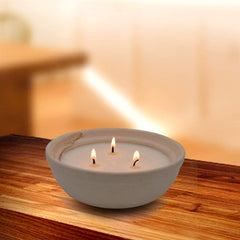 Close up of handmade pottery jar housing citronella candle