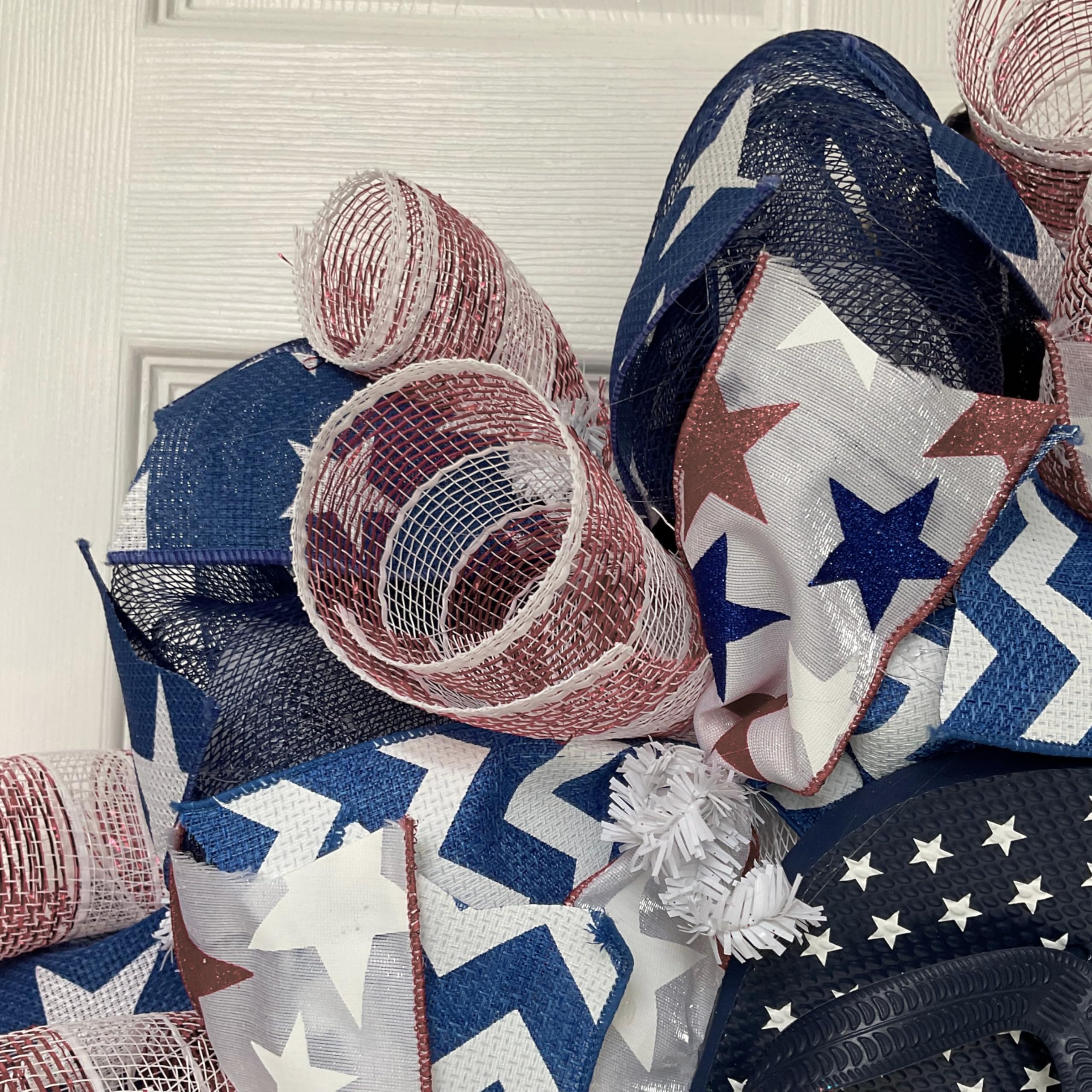 White center ribbon with blue stars on wreath