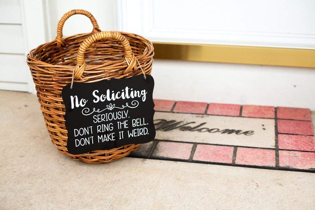 Black chalkboard background with bold No Soliciting message