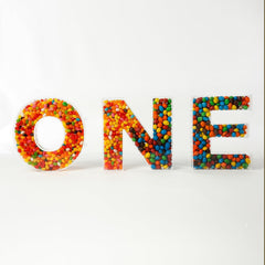 Alphabet letter candy jar display with colorful contents