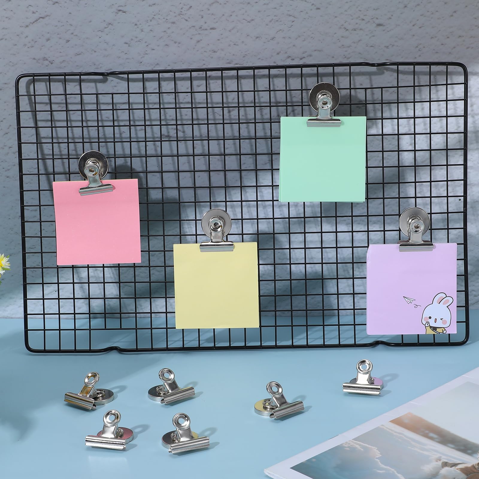 Refrigerator magnet clips securing documents and photos