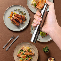 Manual pepper mill with transparent glass body for refills
