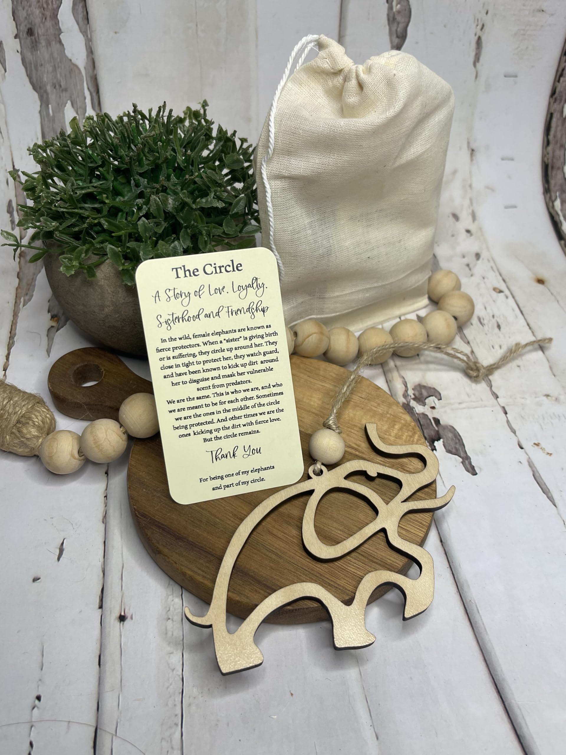 One wooden elephant ornament with story card and cotton pouch