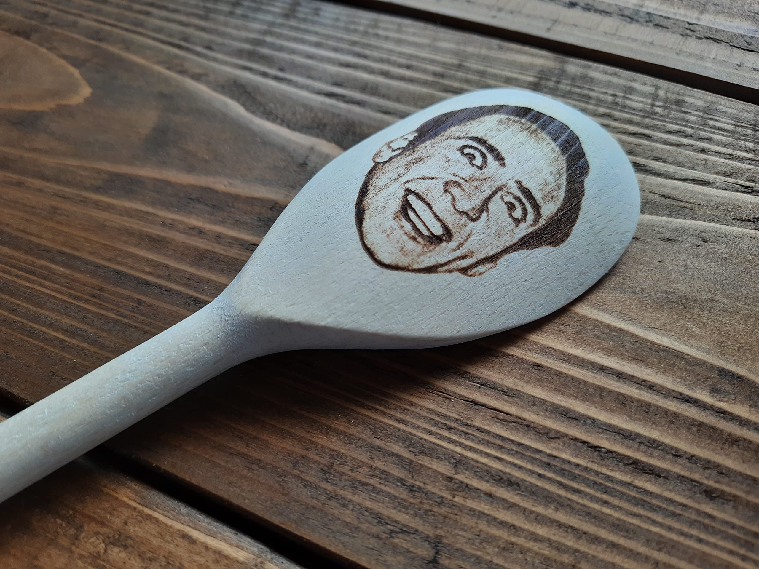 Hand-polished wooden spoon showing natural wood texture