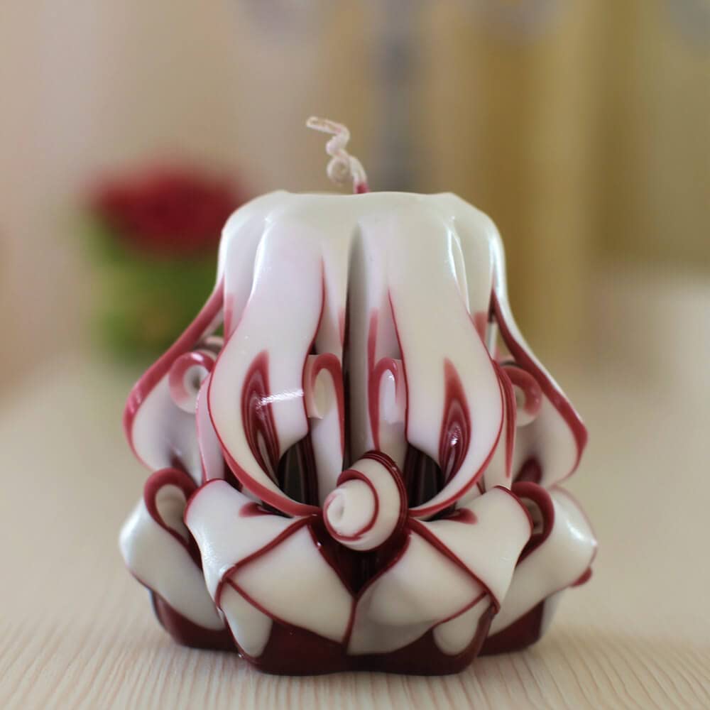 White burgundy carved candle looks like ceramic vase