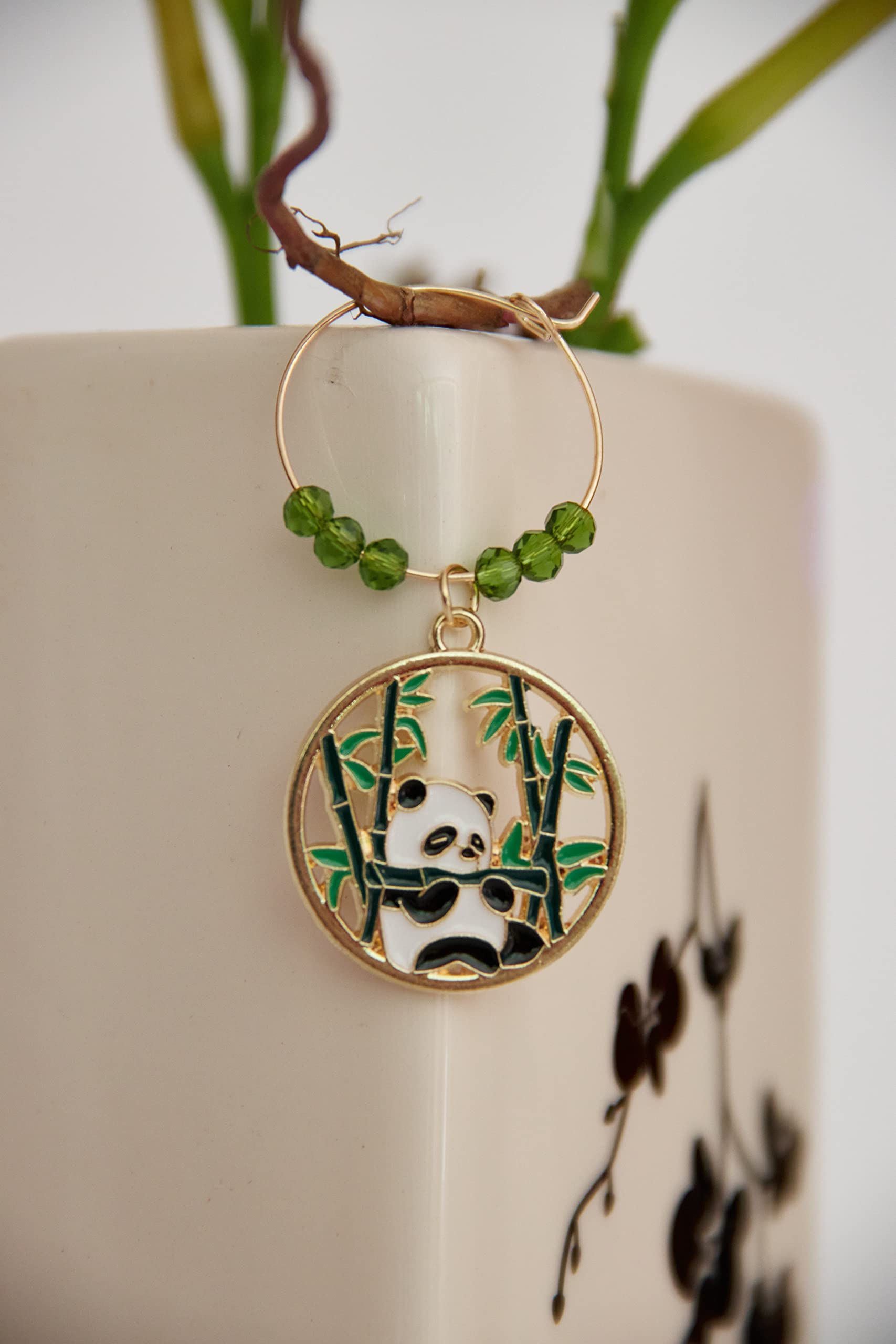 Panda characters and bamboo motif on wine glass charm set