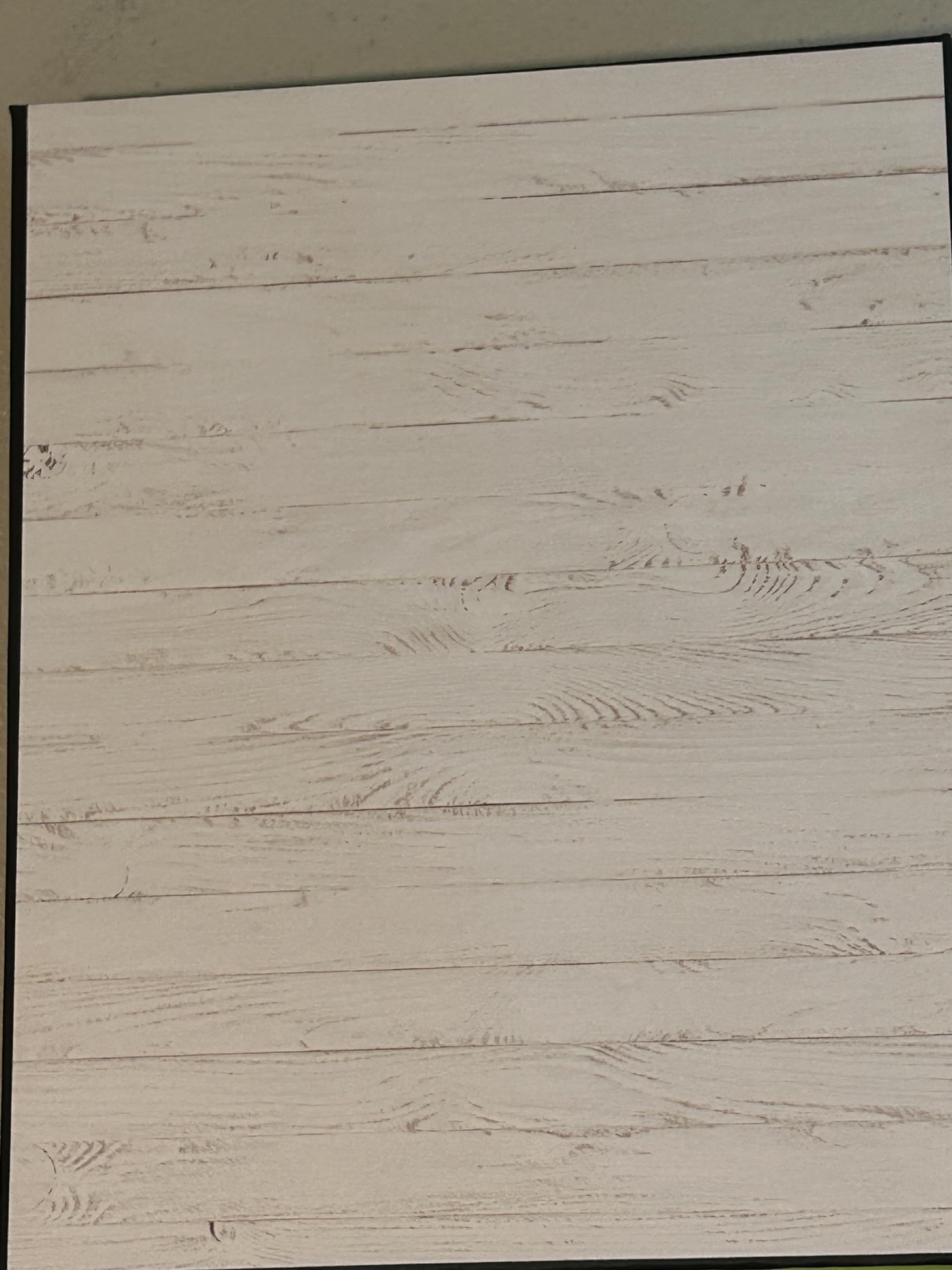 Chipboard cover wrapped in black paper