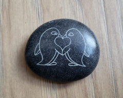 Engraved penguin couple motif on keepsake pebble