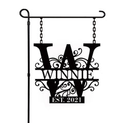 Personalized garden flag outside with last name sign