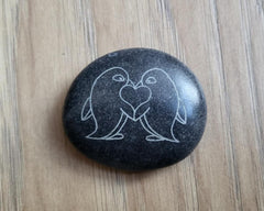 Four penguin love pebbles set showing engraved motifs