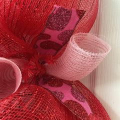 Outer ring with shimmering red deco mesh and pink accents on wreath
