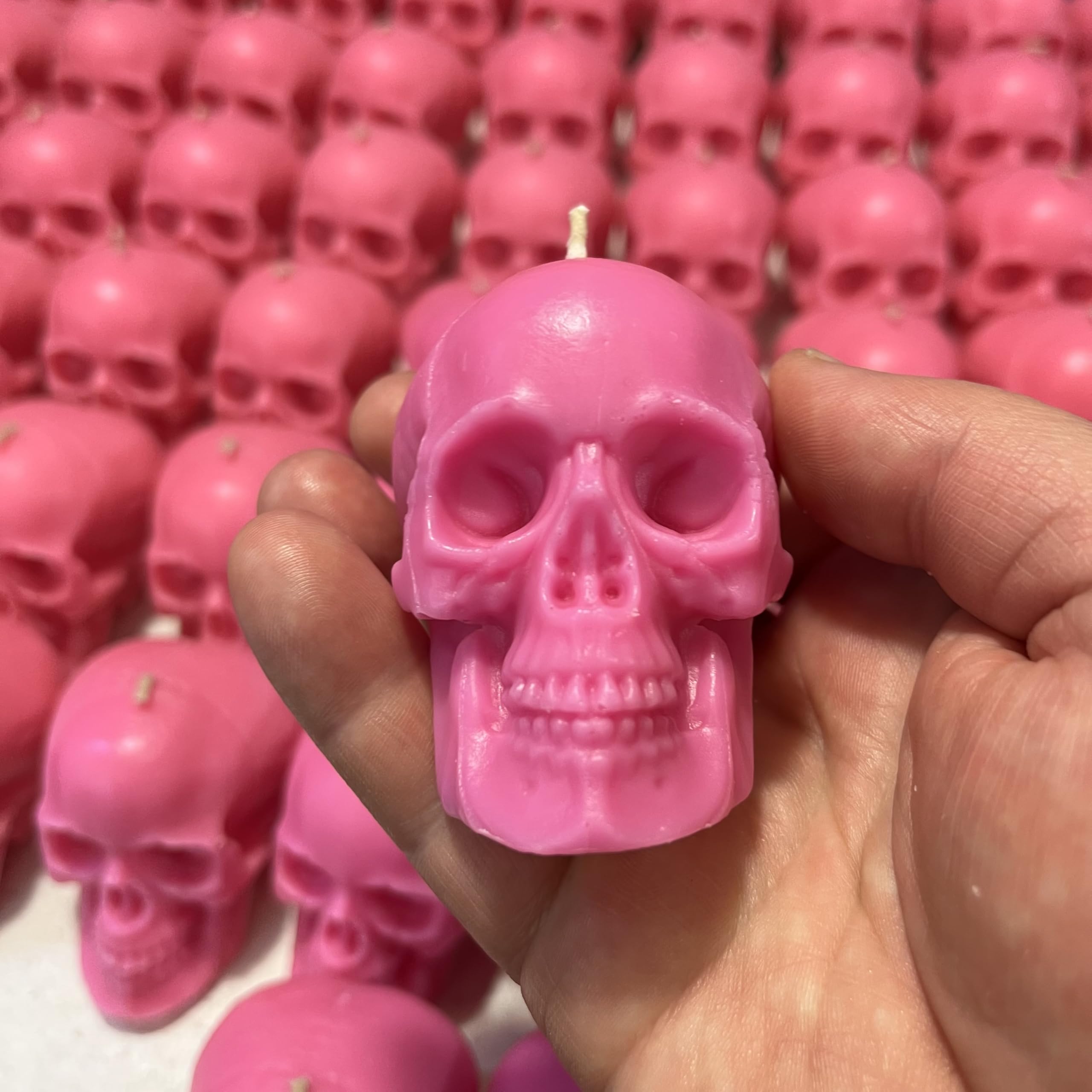 Decorative pink skull candles for rituals and gifts