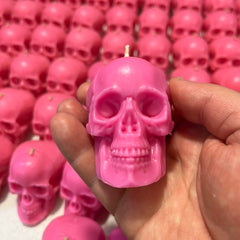 Decorative pink skull candles for rituals and gifts