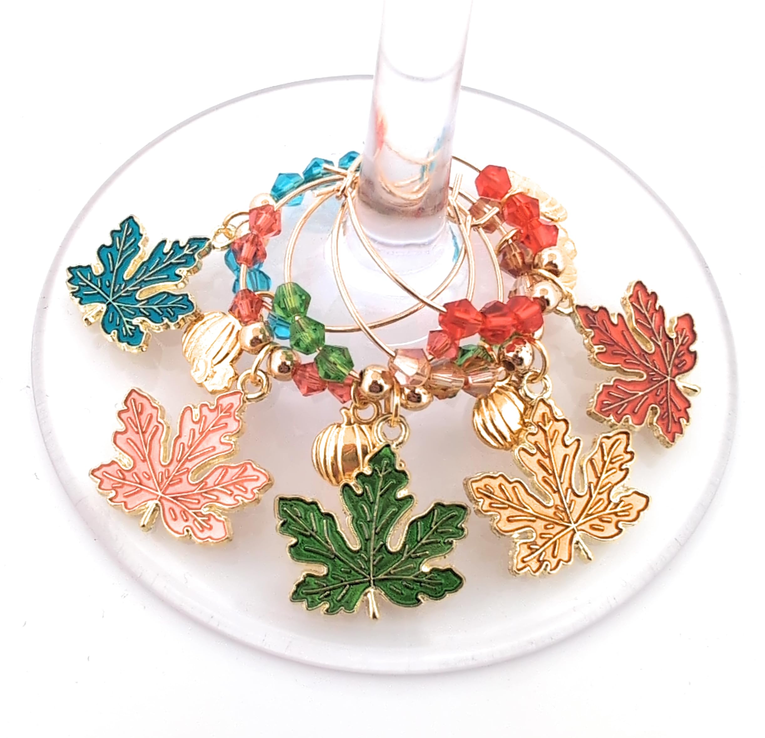 Leaf and pumpkin enamel charms on gold-tone wine rings by Pixie