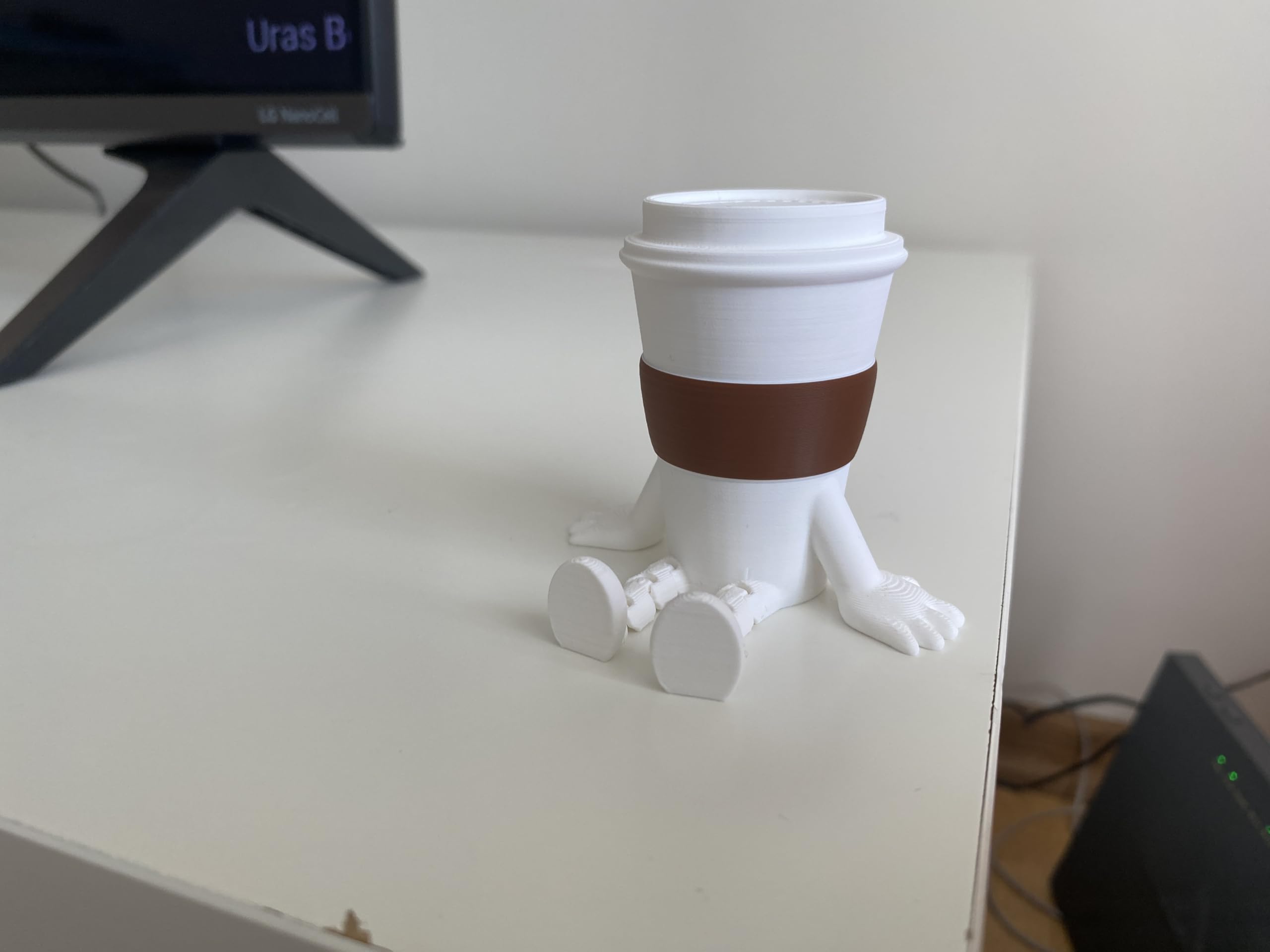 Compact coffee cup figurine sized 2.5 x 2.7 x 2 inches on shelf