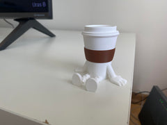 Compact coffee cup figurine sized 2.5 x 2.7 x 2 inches on shelf