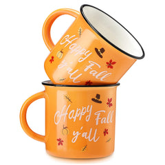 Two orange pumpkin themed ceramic mugs