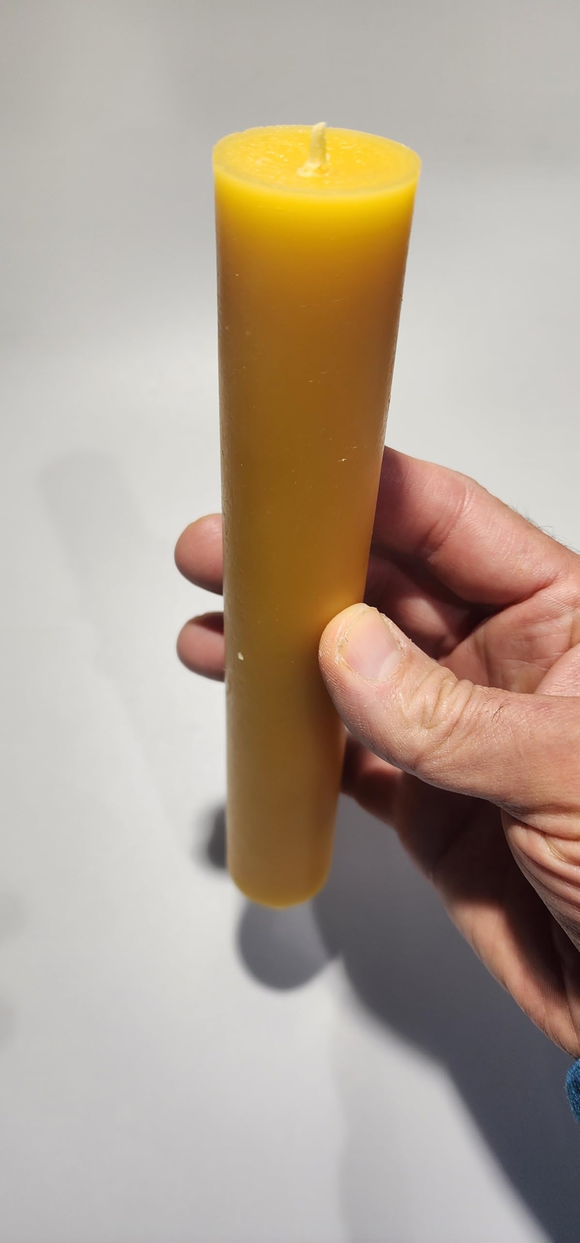 Pillar candle with natural beeswax color and cotton wick