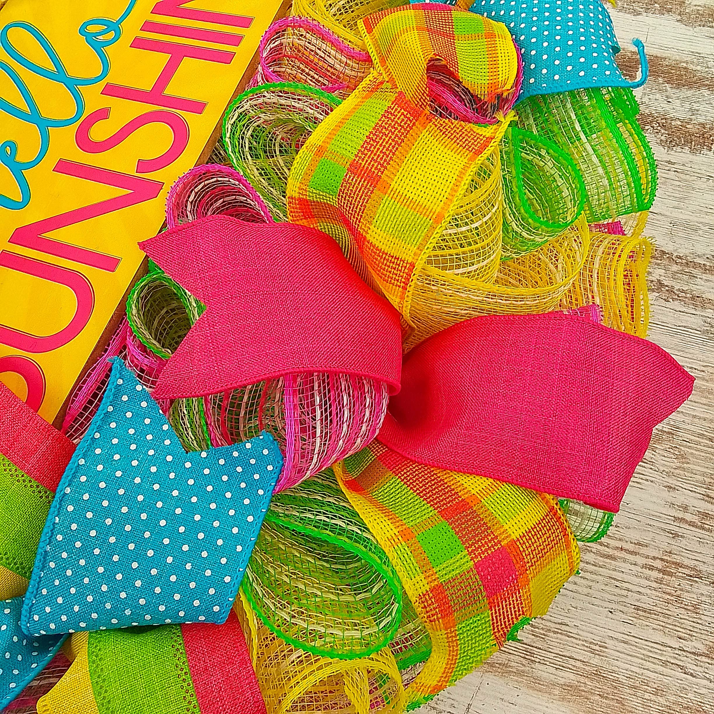Coordinating ribbons on pink yellow mesh wreath